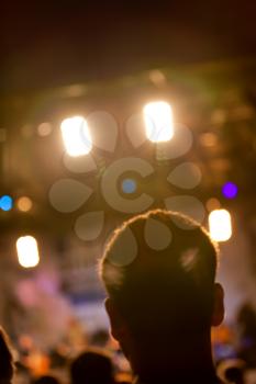 Man head silhouette with concert lights during the show
