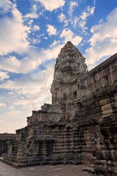 Tower in Angkor Wat temple with blue sky and clouds, Siem Reap, Cambodia
