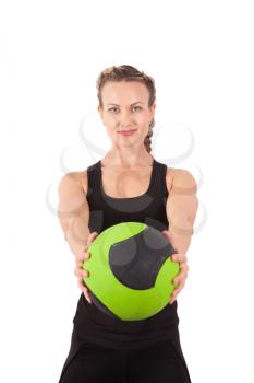 Athletic young woman training with green ball isolated on white
