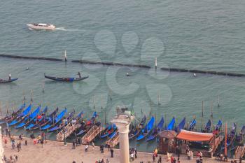Gondola pier near San Marco Campanile with people, top view
