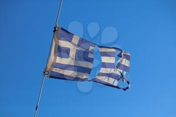 Torn greece flag waving on the wind

