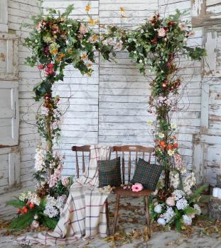Vintage frame made from flowers, leaves with the grunge wooden background
