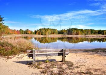 Royalty Free Photo of a Bench by a Lake