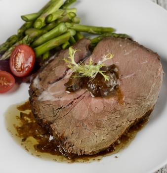 Slice Of Beef Roast With Asparagus And Tomatoes