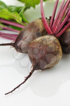 fresh beet roots with leaves on white background,
