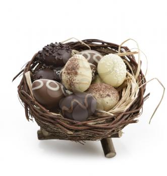 Chocolate Eggs Collection In A Nest On White Background