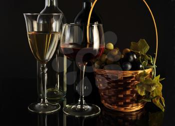 red and white wine with fruits on black background