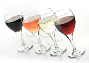 glasses of pink , red and white wine on white background 
