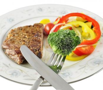 a steak and fresh vegetables, close up
