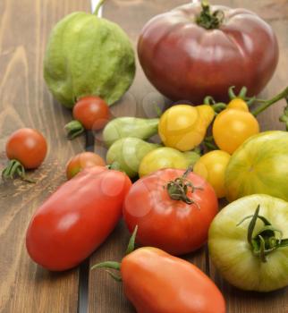 Tomatoes Assortment On Wooden  Background