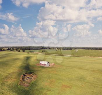 Countryside with fields ,old barn and small pond. Aerial view. Summer landscape.