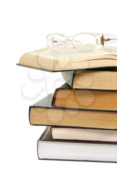 Books with glasses isolated on white 