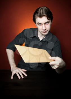 Young man with brown envelope. 