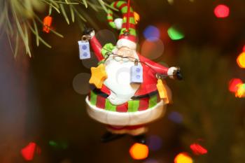 santa claus christmas decoration on fur tree with lights