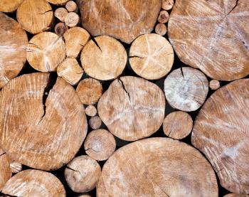 Stacked logs, wooden background