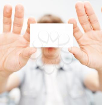 Man holding blank business card with copy space, small dof 