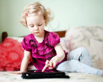 Cute little girl using tablet computer 
