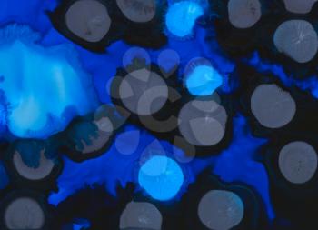 Blue with black spots paint.Colorful background hand drawn with bright inks and watercolor paints. Color splashes and splatters create uneven artistic modern design.
