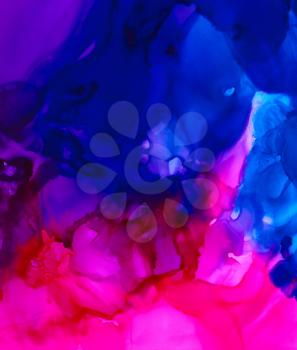 Bright purple over blue smooth paint.Colorful background hand drawn with bright inks and watercolor paints. Color splashes and splatters create uneven artistic modern design.