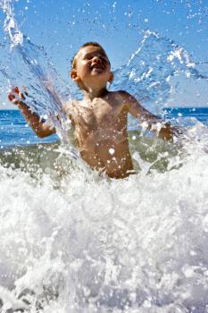 Young child playing in the sea