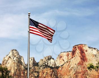 Royalty Free Photo of an American Flag and Mountains