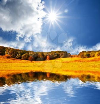 Royalty Free Photo of a Field and Pond in Autumn