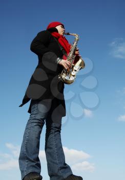 Royalty Free Photo of a Woman Playing a Saxophone