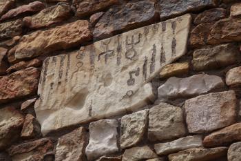 Royalty Free Photo of a Brick Wall and Hieroglyphs