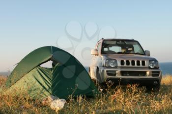 Tent and car on sea shore