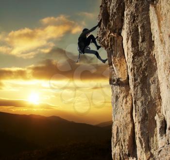 Royalty Free Photo of a Rock Climber at Sunset
