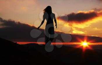 Royalty Free Photo of a Female Silhouette at Sunset