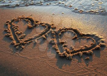 Royalty Free Photo of Hearts Drawn in the Sand