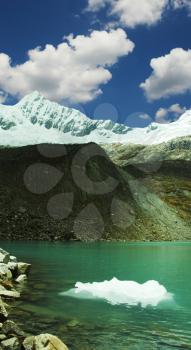 Royalty Free Photo of a Green Lake and Iceberg in the Cordillera Mountains