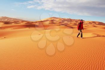 Royalty Free Photo of a Man Walking in the Desert