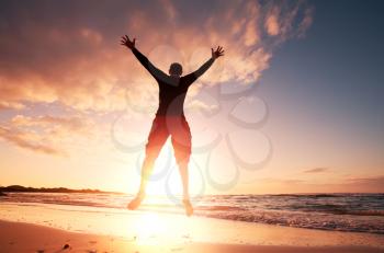 Royalty Free Photo of a Boy Jumping at the Beach