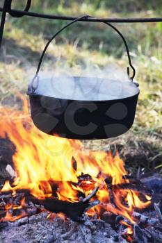 Royalty Free Photo of a Kettle Over a Fire