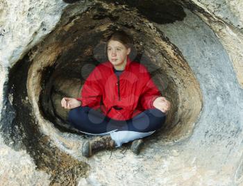 Royalty Free Photo of a Woman Meditating in a Cave