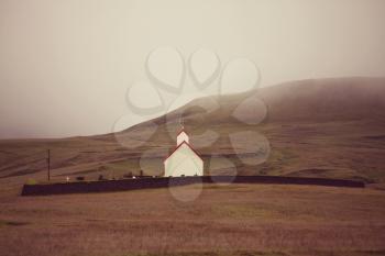 Rural icelandic landscapes. Chapel in foggy mountains.