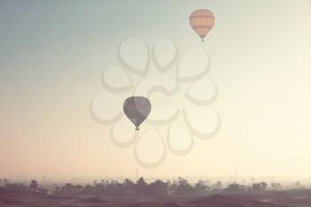 Balloons above african oazis. Travel natural background.