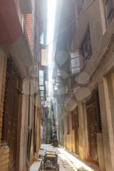 narrow street with tall houses in historical Kathmandu  city, Nepal