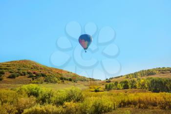 balloons above green hills. Travel natural background.