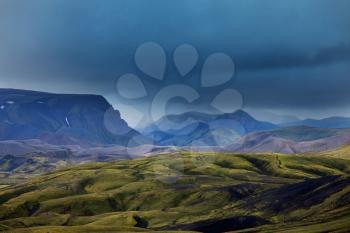 Beautiful Icelandic landscape. Green volcanic mountains in cloudy weather.