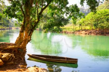 Wooden boat in beautiful green river in Guatemala, Central America