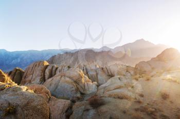 Hiker in unusual stone formations in Alabama hills, California, USA