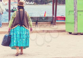 Woman in traditional dress in Titicaca quay in Bolivia