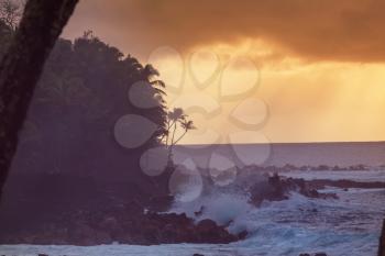 Amazing hawaiian beach. Wave in ocean at sunset or sunrise with surfer. Wave with warm sunset colors. Oahu beach, USA.