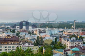 Kiev city. Old town. Ukraine. Beautiful view of the ancient street Andrew's Descent and the St. Andrew's Church among green trees of the Castle Hill in Kyiv