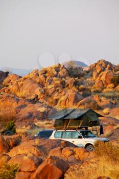 Offroad 4x4 vehicle with tent in the roof ready for camping in the desert