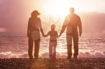 Family on the beach on sunset.