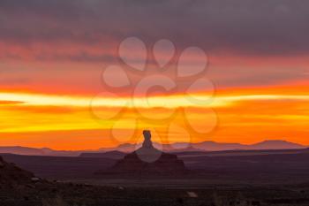 Valley of the Gods rock formation with Monument Valley at sunrise
